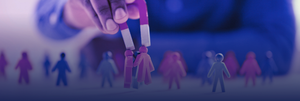 Personality quizzes illustrated through a hand using a magnet to attract colorful human-shaped figures, symbolizing how assessments can group or draw in different personality types.